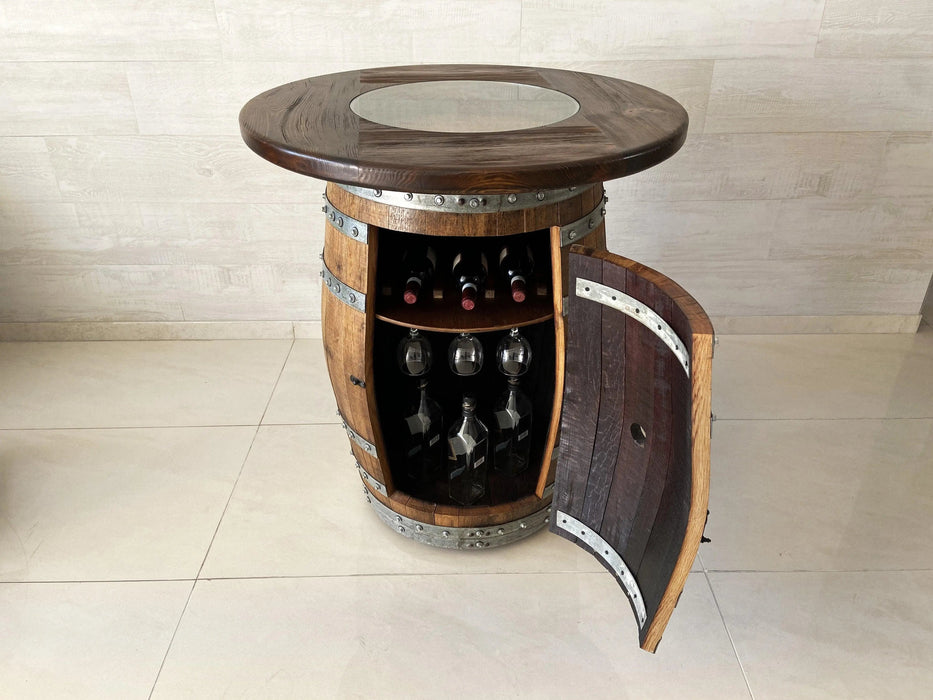 Wooden barrel-style table with wine bottles and glasses inside, on a light tiled floor.