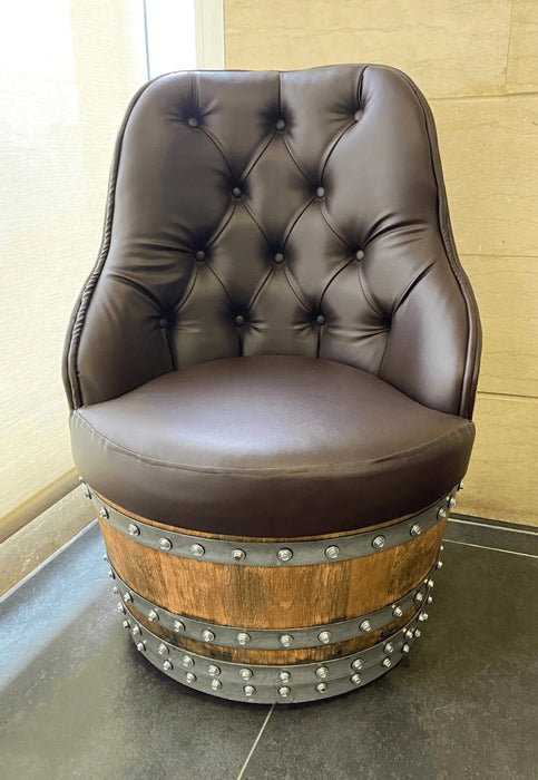 Brown leather chair on a wooden barrel base in a room with tiled floor and wall.