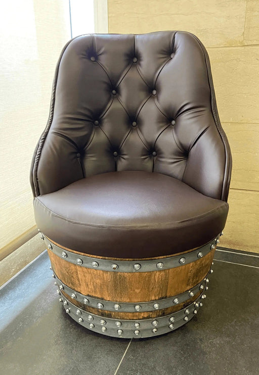 Brown leather chair on a wooden barrel base in a room with tiled floor and wall.