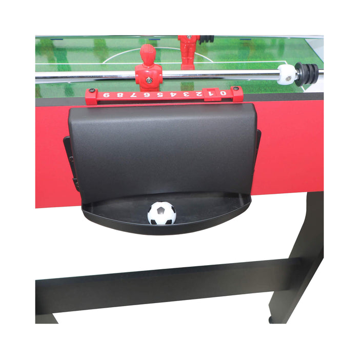 Close-up of a foosball table with a goal and scoring area.
