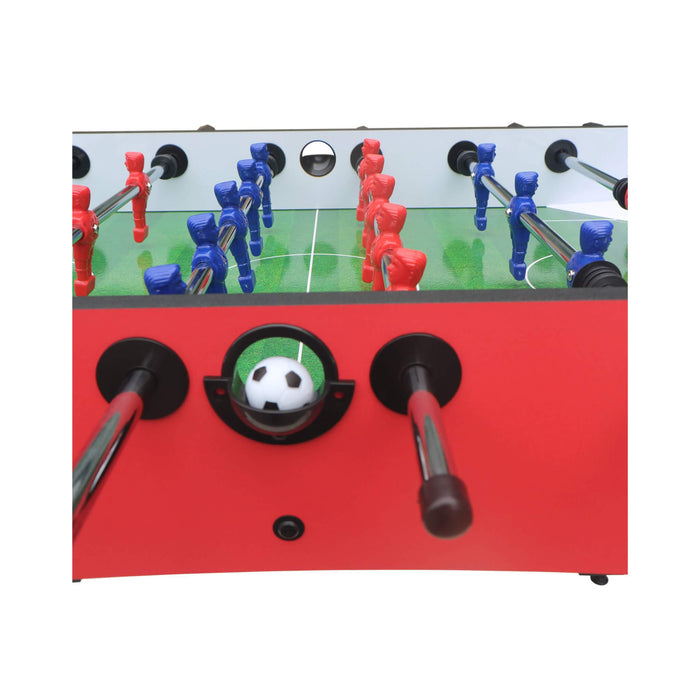 Tabletop soccer game with red and blue player figures on a white background
