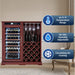 Wine cabinet with wine bottles, glasses, and features displayed on a beige wall.