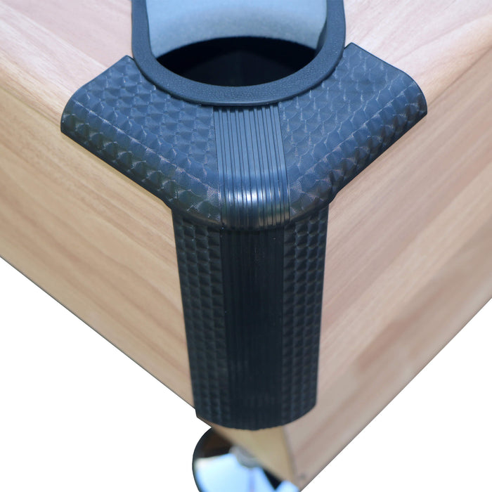 Black rubber corner protector on a wooden surface
