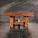 Wooden table against a concrete wall