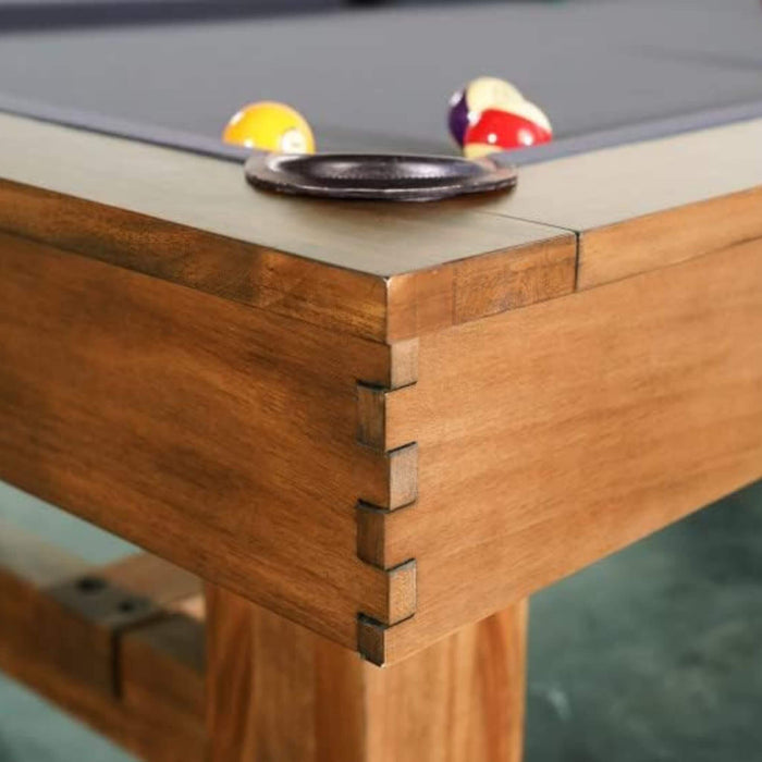 Close-up of a pool table with balls and a pocket.