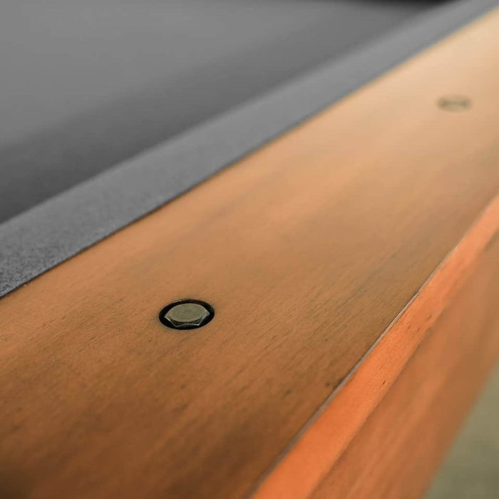 Close-up of a wooden surface with a metal screw.
