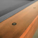 Close-up of a wooden surface with a metal screw.