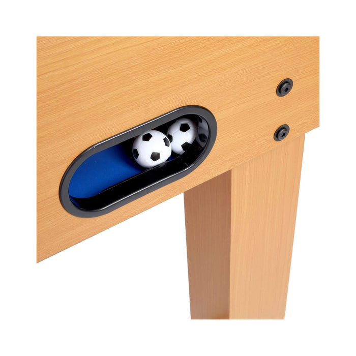 Wooden table with a small compartment containing two soccer balls on a white background