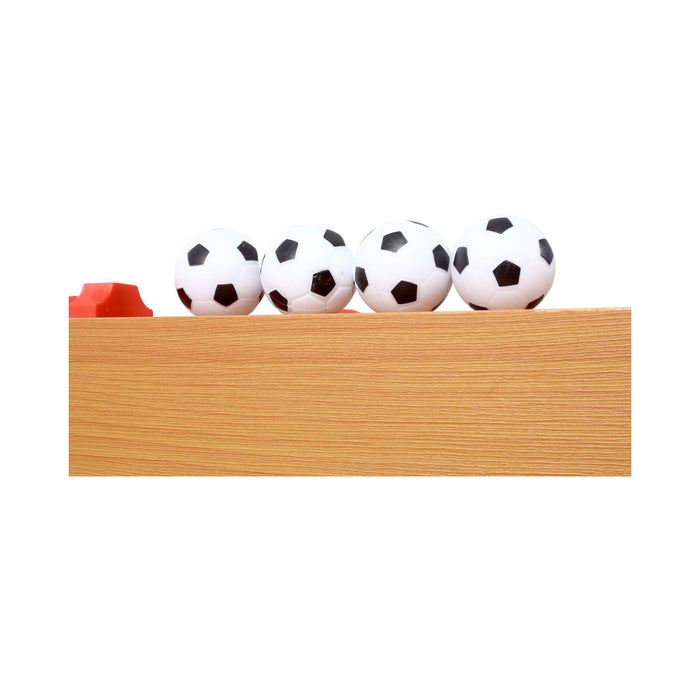 Four soccer balls on a wooden shelf with a white background