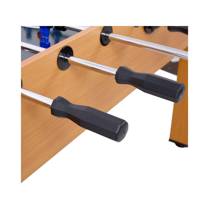 Close-up of table football (foosball) table with wooden surface and metal rods.