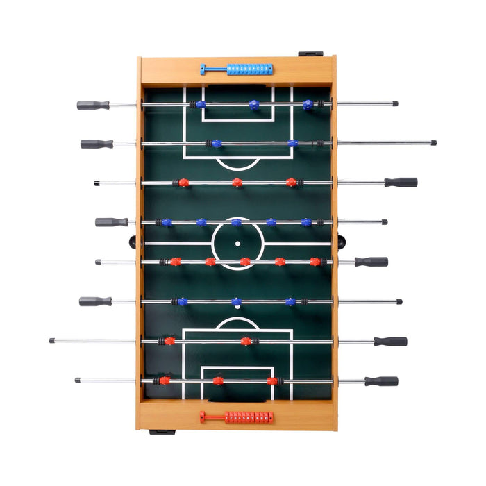 Foosball table with green playing surface and wooden frame on a white background