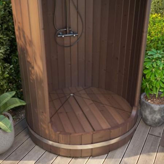 Wooden outdoor shower enclosure with plants in the background