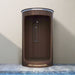 Wooden shower enclosure with a shower head against a neutral wall.