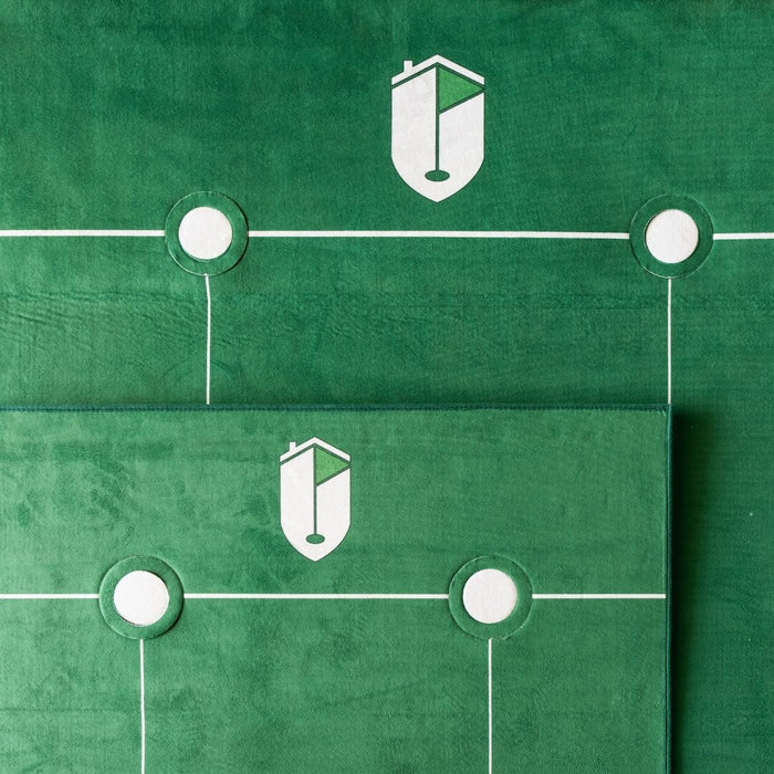 Green surface with white lines and circular elements, featuring a logo.