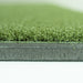 Close-up of green artificial grass with a white background