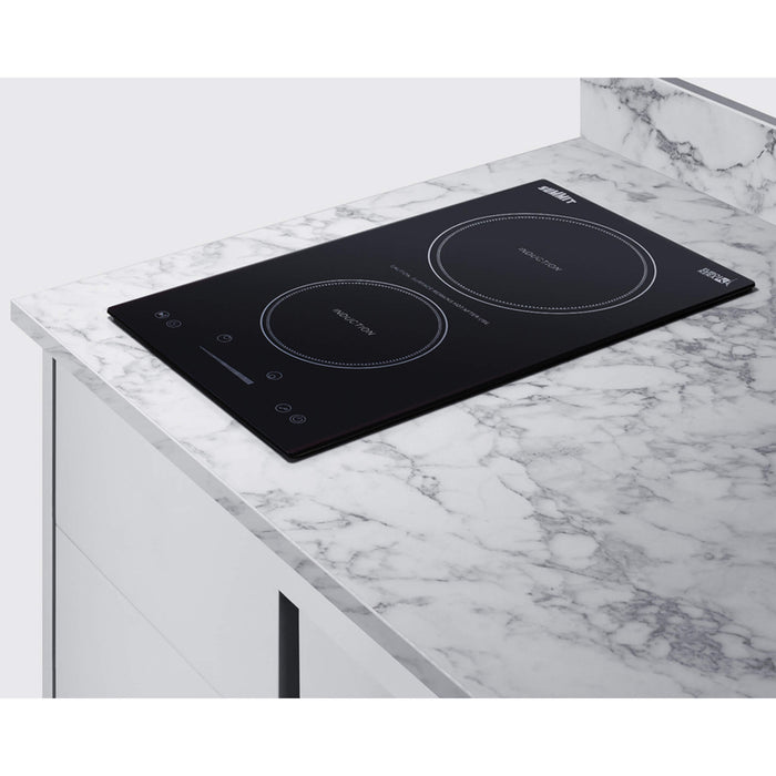 Black induction cooktop on a marble countertop