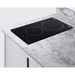 Black induction cooktop on a marble countertop