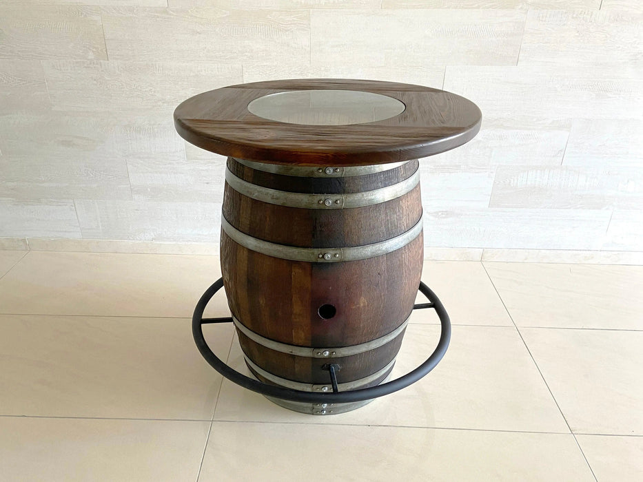 Wooden barrel side table with a round top on a light tiled floor.