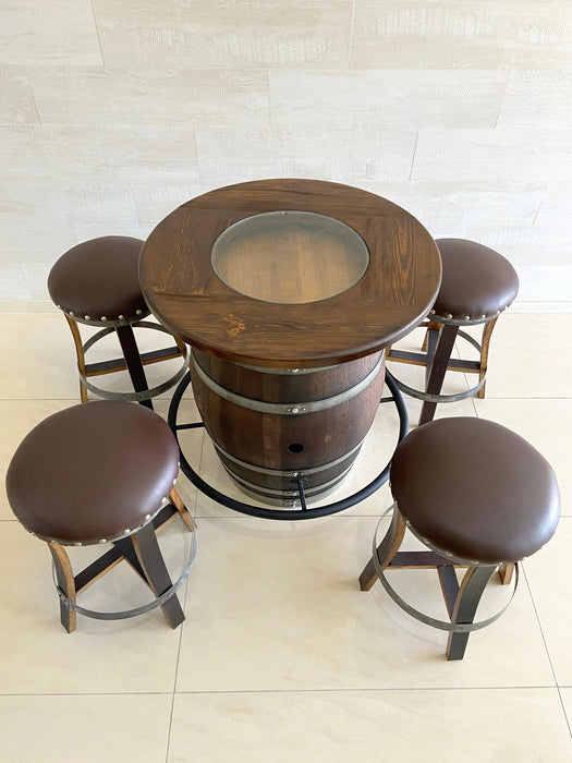 Wooden barrel table with four stools on a tiled floor.