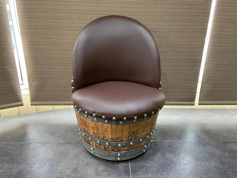 Brown leather chair on a wooden barrel base in a room with curtains.
