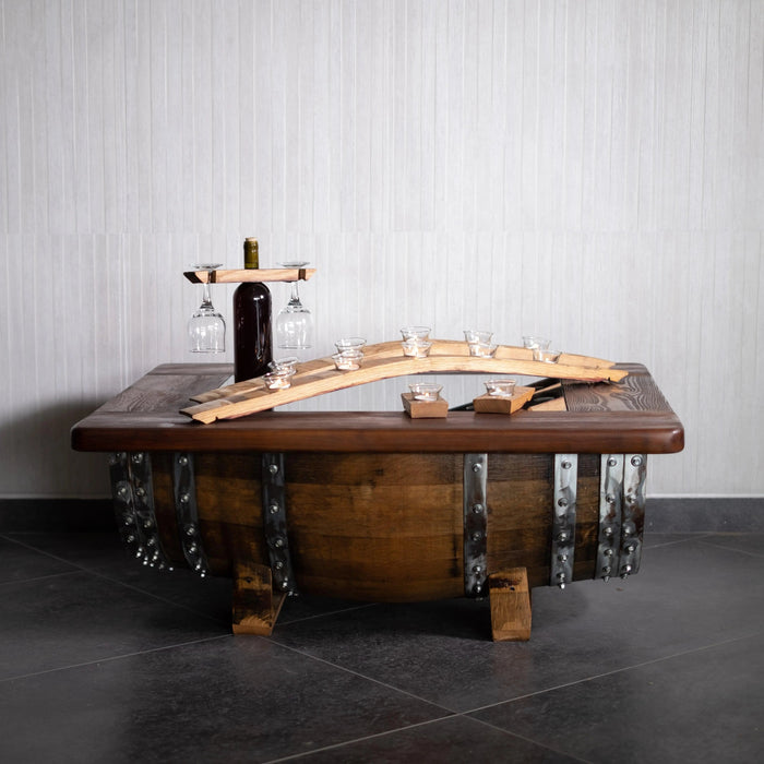 Wooden table with metal accents and wine bottle holder against a gray wall.