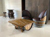 Wooden table and chairs made from repurposed wine barrels in a modern interior setting.