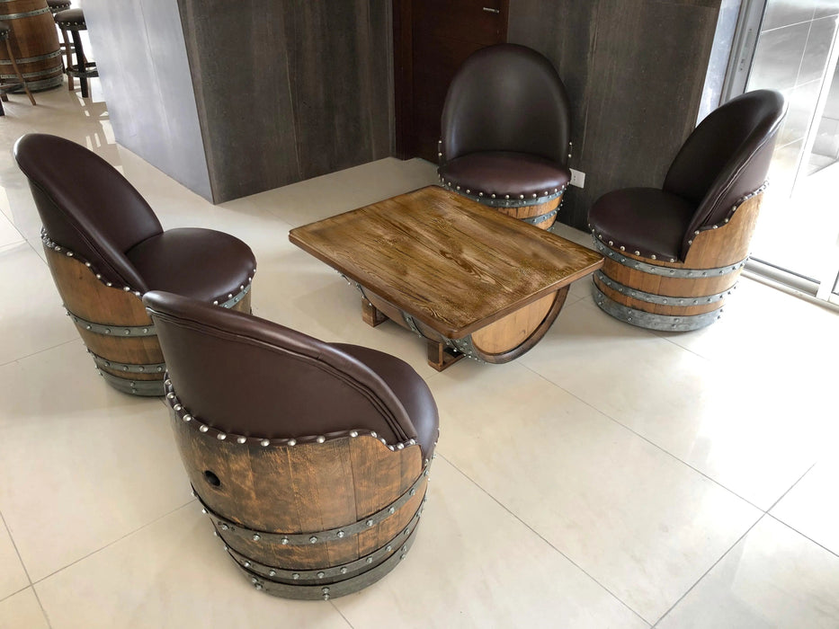 Wooden barrel chairs with a matching table on a tiled floor.